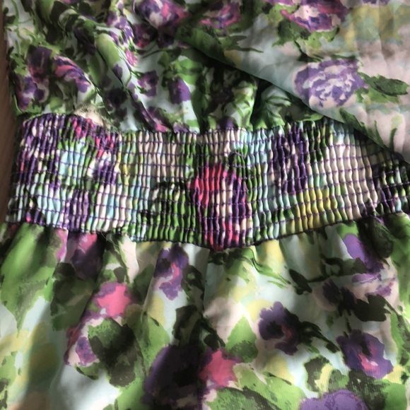 This is a floral jumpsuit with a scarf attached to the top of it on one side. - Picture 4 of 7